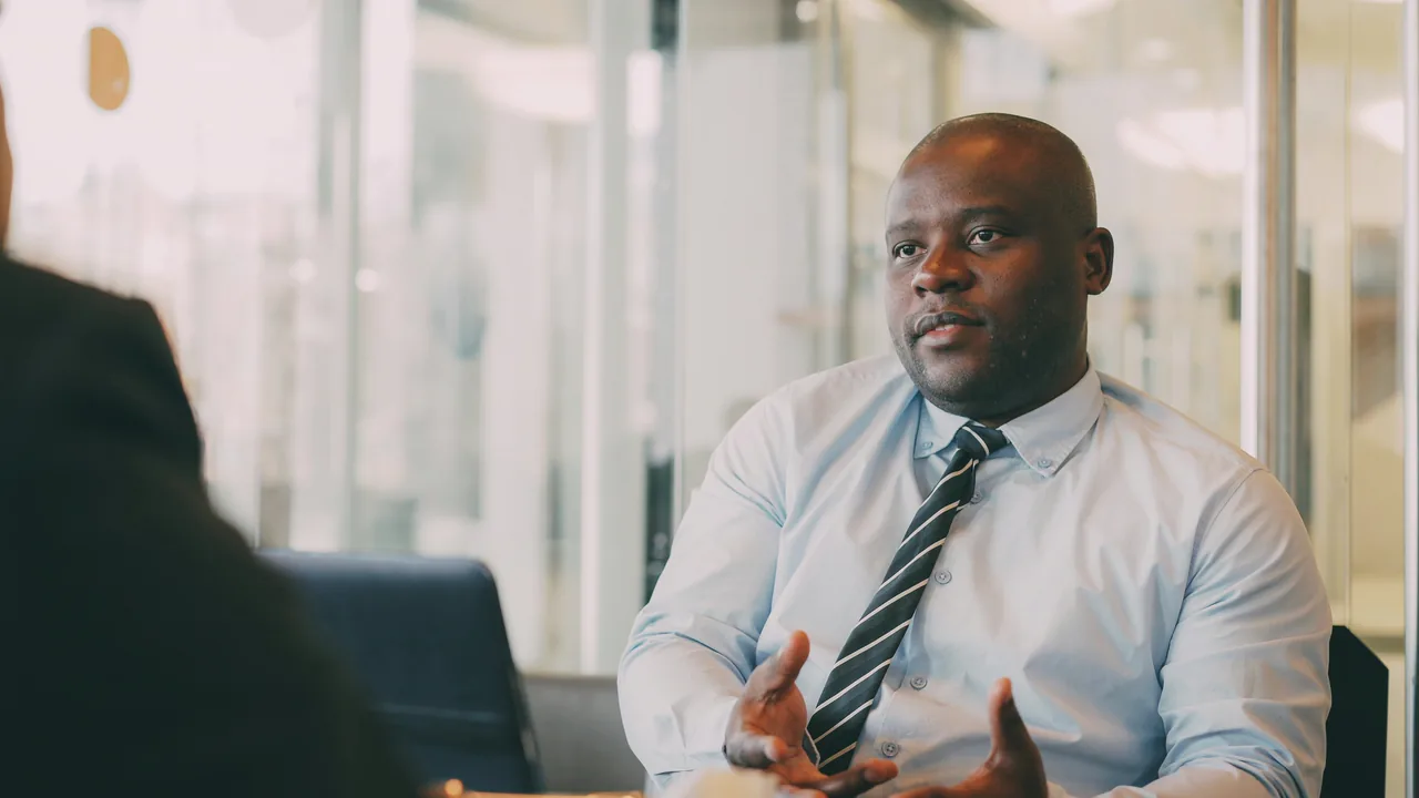 An attorney advising a client in a bright office